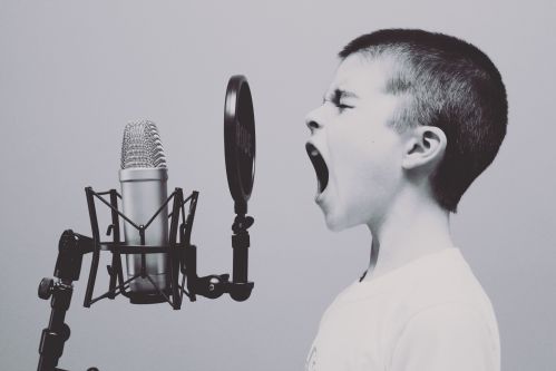 Boy screaming in a microphone